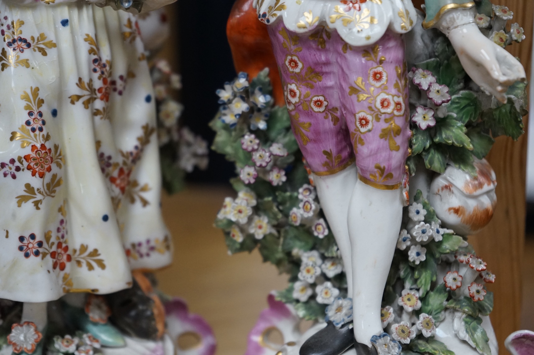 A pair of 18th century Derby porcelain figures of a lady and gentleman, 27cm high